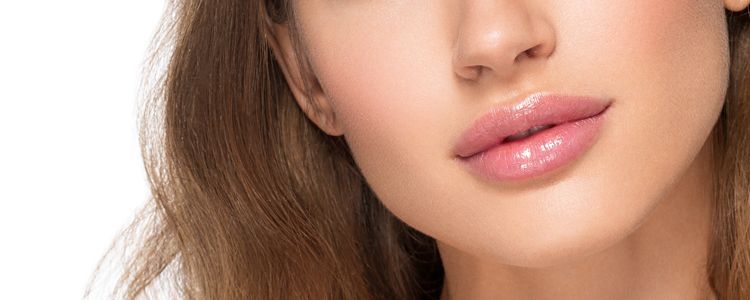 A close up of a woman 's face with pink lips.