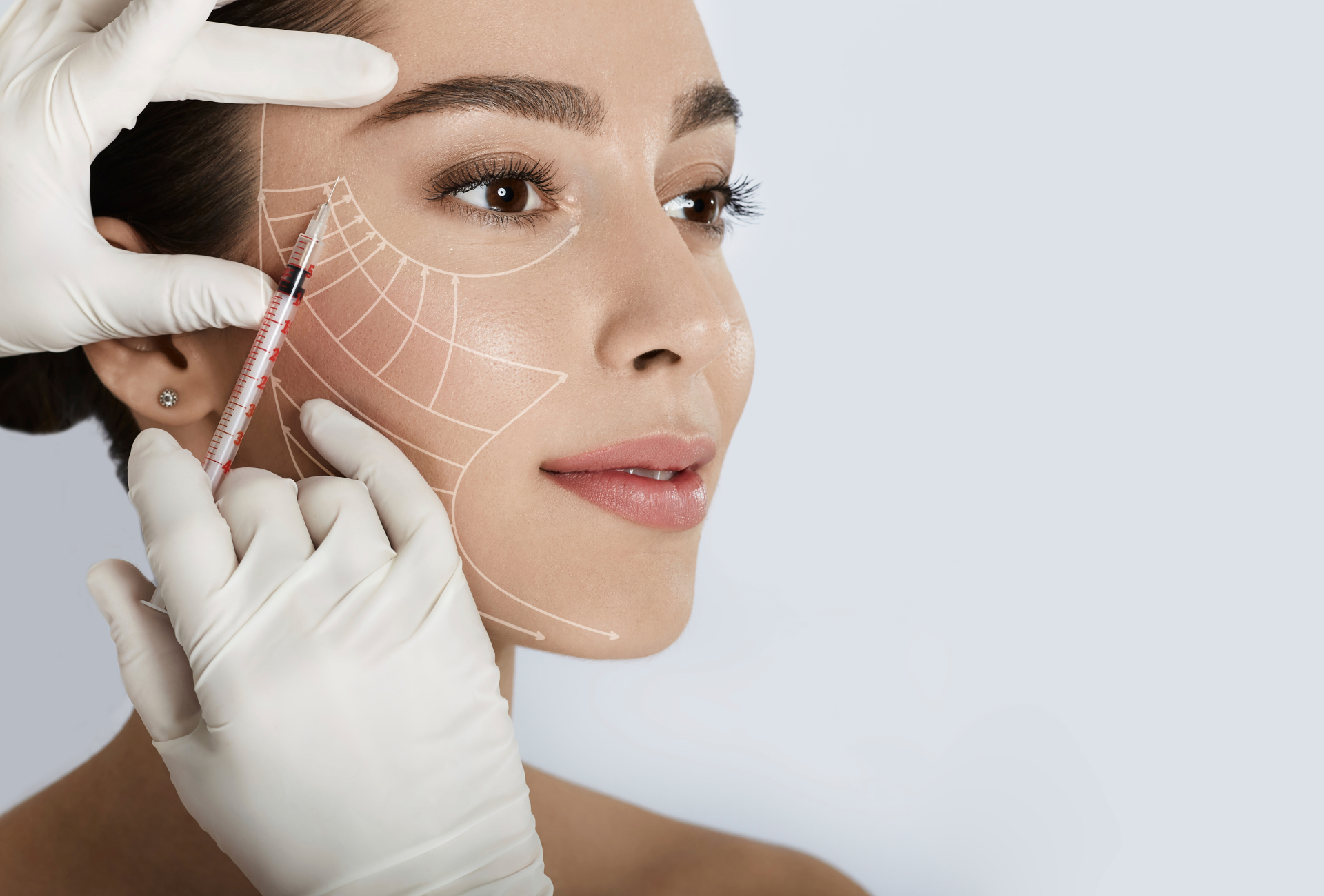 A woman is getting a botox injection in her face.