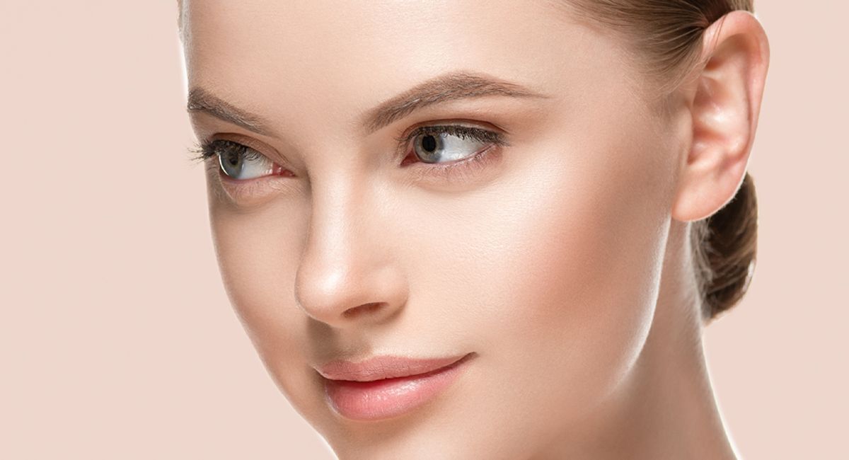 A close up of a woman 's face with a healthy skin.