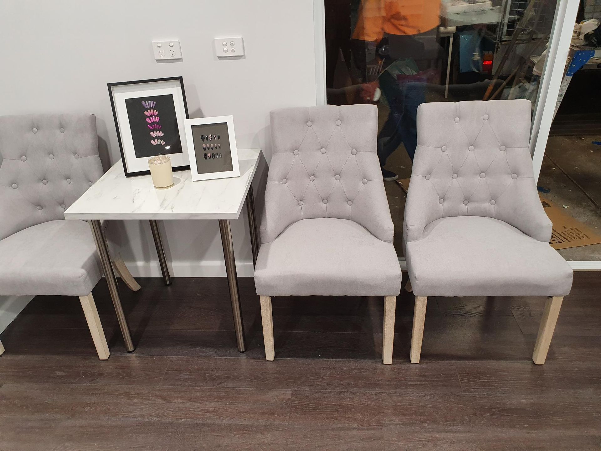 Three Gray Tufted Chairs Near a Small Table with Framed Art — Mezcon Renovations & Maintenance in Heidelberg, VIC