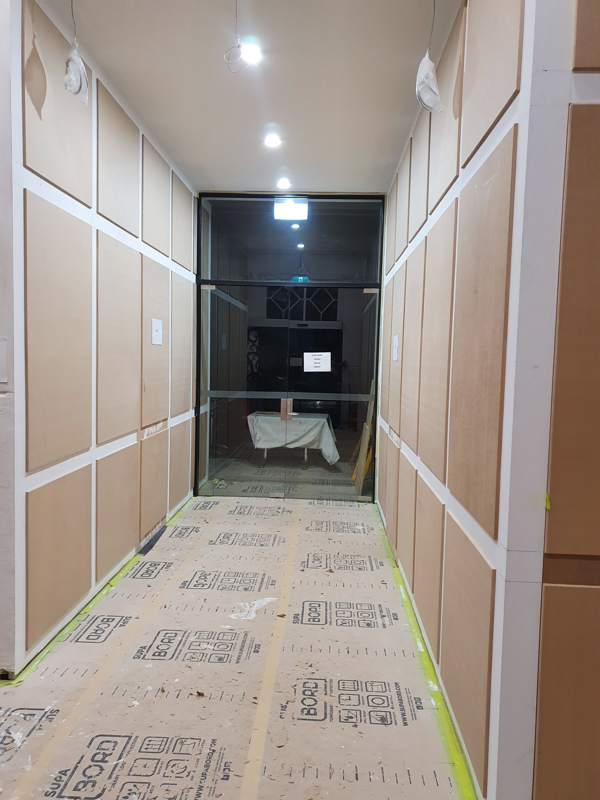 An Empty Room with Stairs and A Wooden Railing — Mezcon Renovations & Maintenance in Heidelberg, VIC