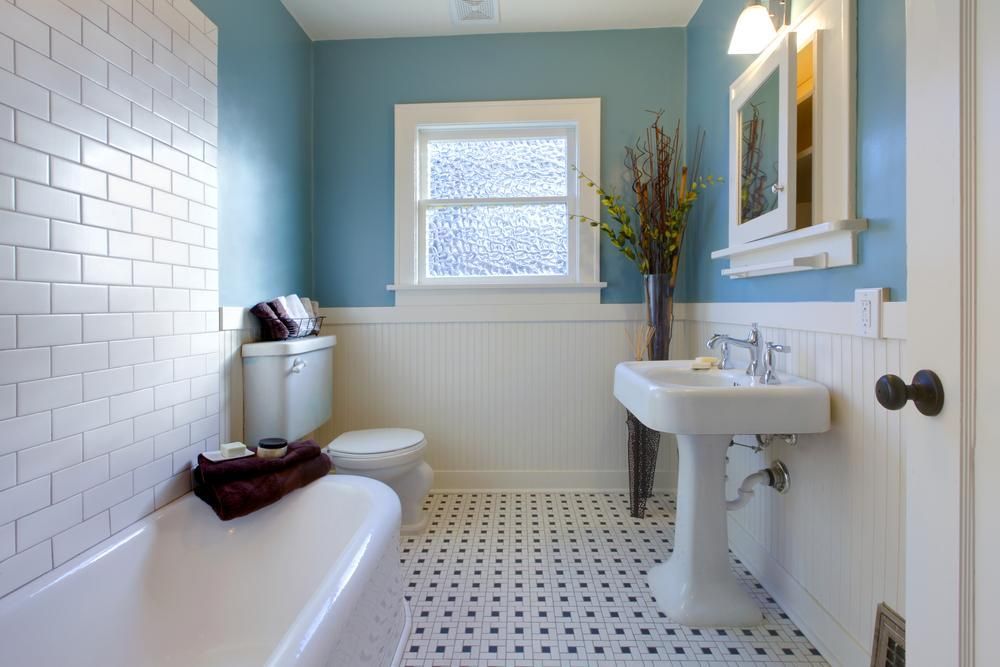 A Bathroom with Blue Walls and White Tiles — Mezcon Renovations & Maintenance in Eaglemont, VIC