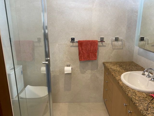 Bathroom with shower, toilet, vanity, and beige and brown accents — Mezcon Renovations & Maintenance in Heidelberg, VIC
