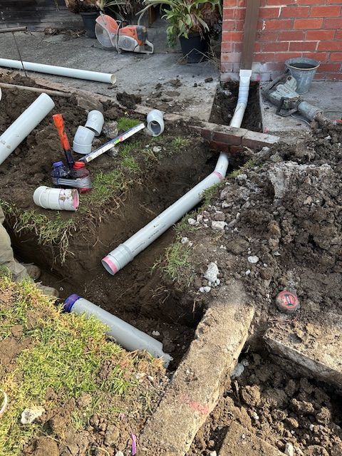 Plumbing work in progress: grey PVC pipes, fittings, and tools — Mezcon Renovations & Maintenance in Heidelberg, VIC