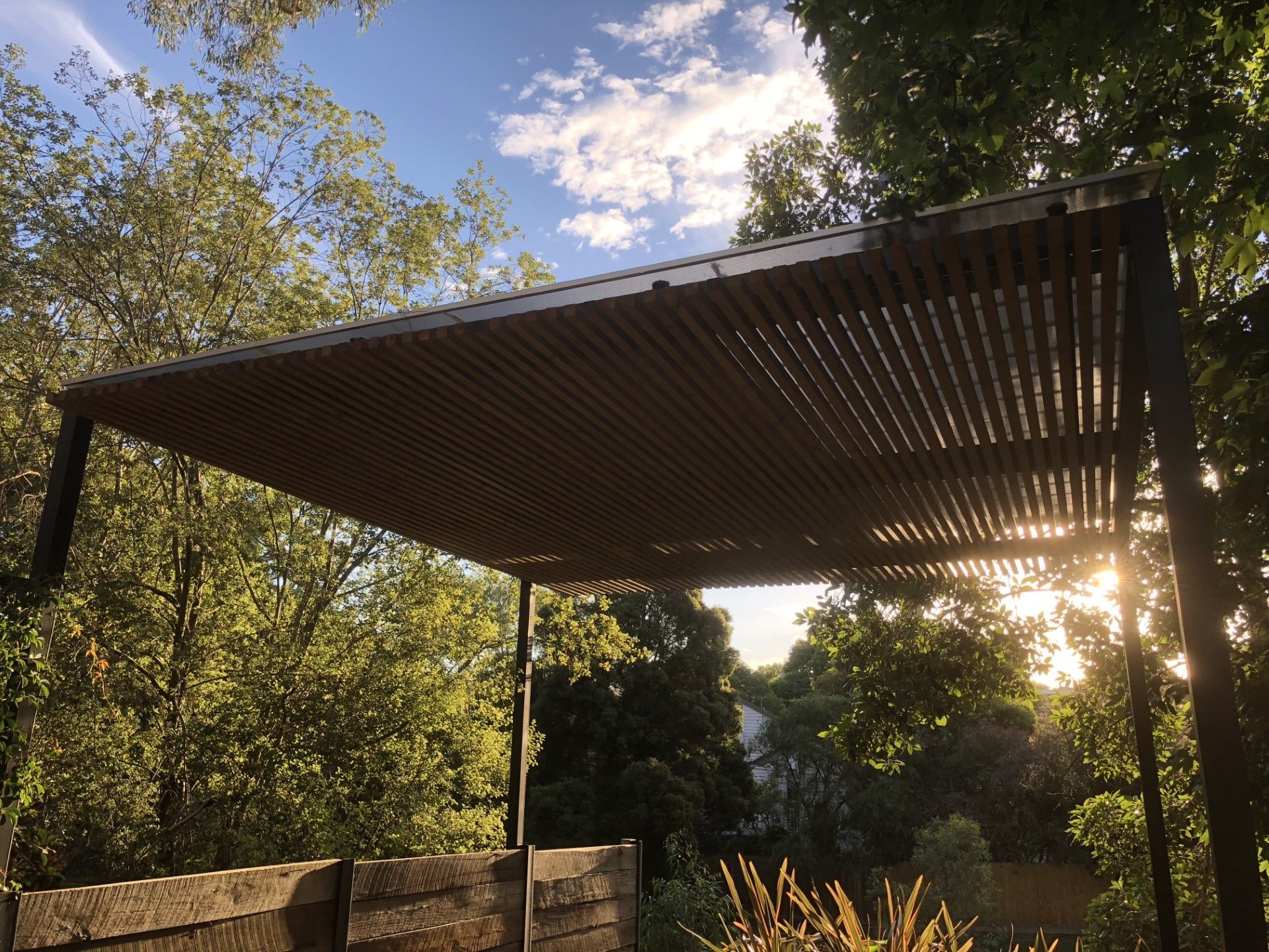 wooden pergola with the sun shining through— Mezcon Renovations & Maintenance in Bulleen, VIC