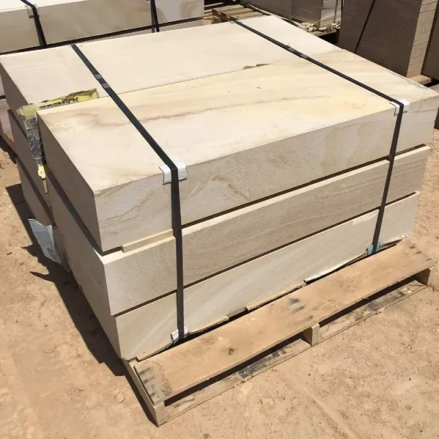 A pallet of sandstone blocks is sitting on the ground