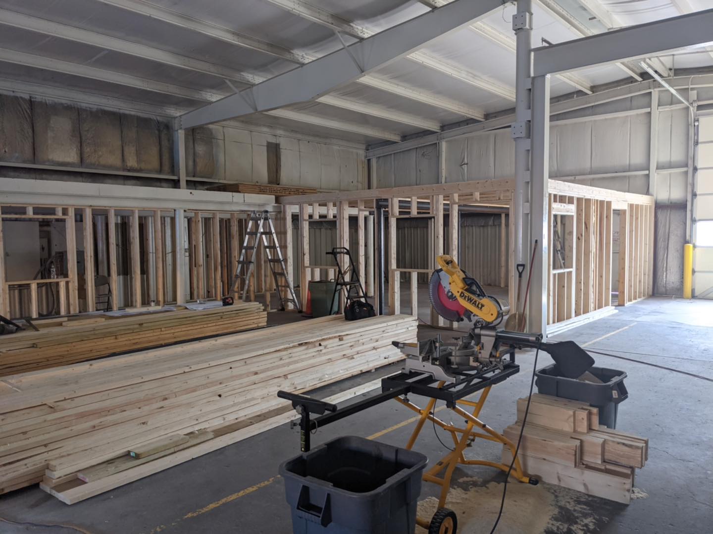 A person is using a circular saw in a building under construction.