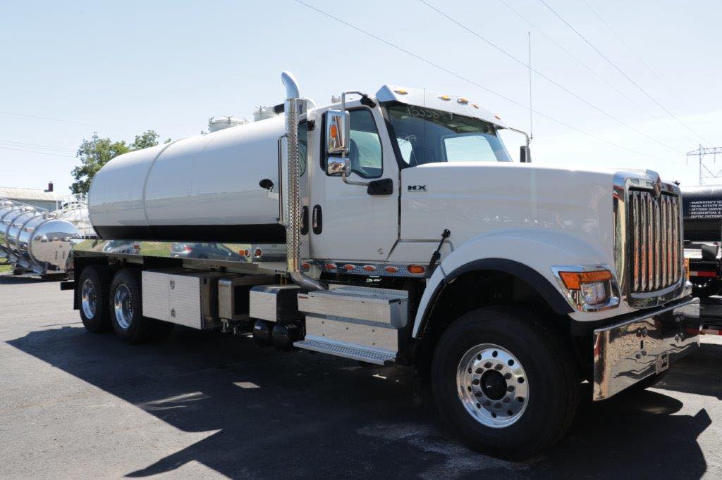 A large white truck is parked on the side of the road.