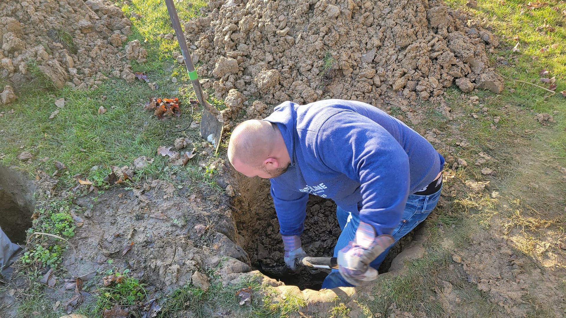 Digging out a manhole cover | John Kline Septic