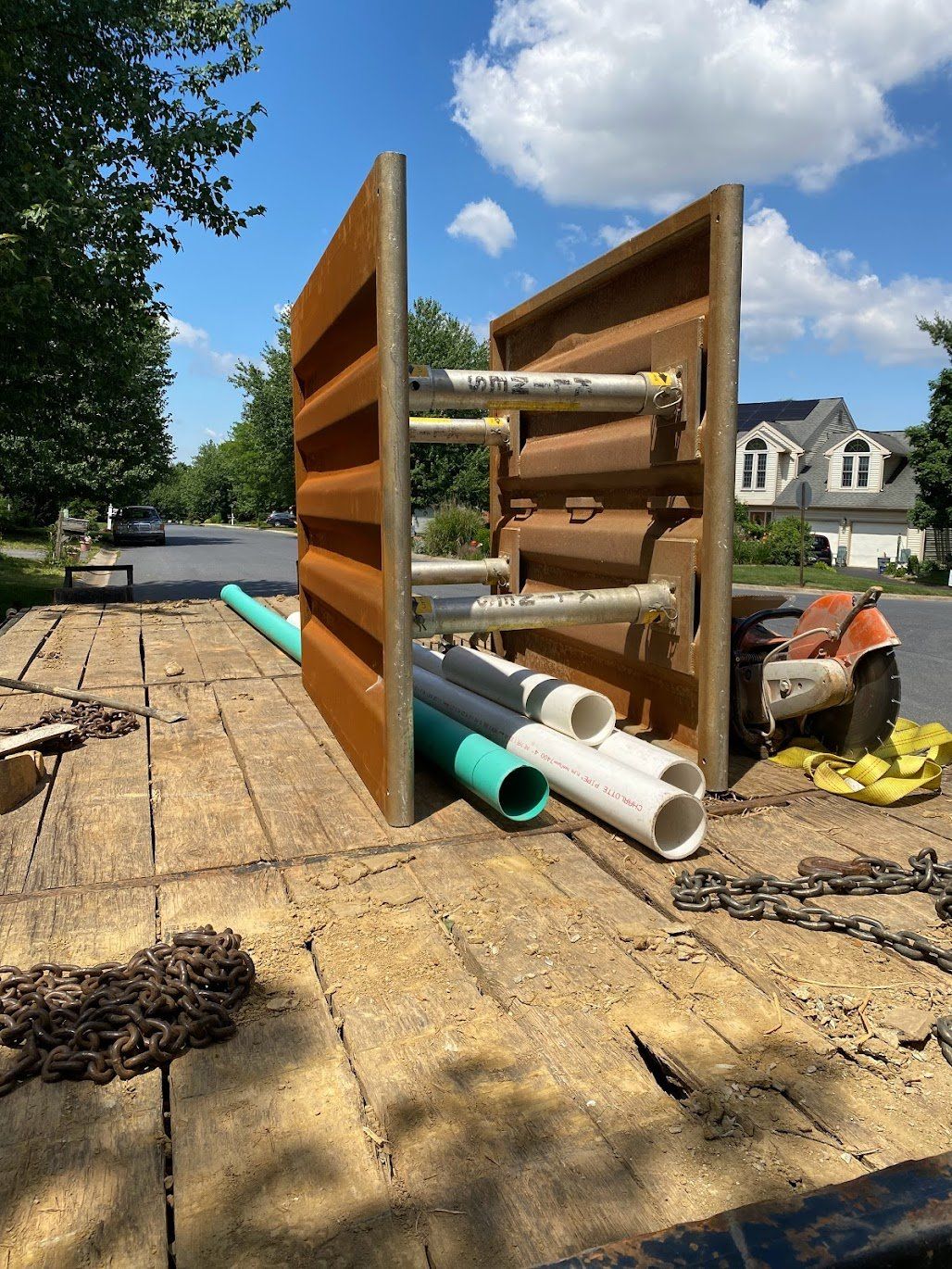 A large piece of wood is sitting on top of a wooden deck.