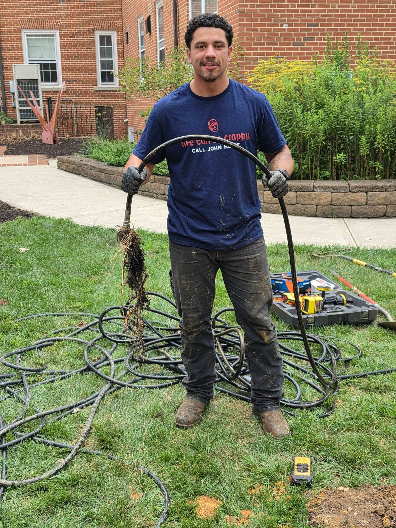 septic pumping technician uncovering a root system disrupting a sewer line