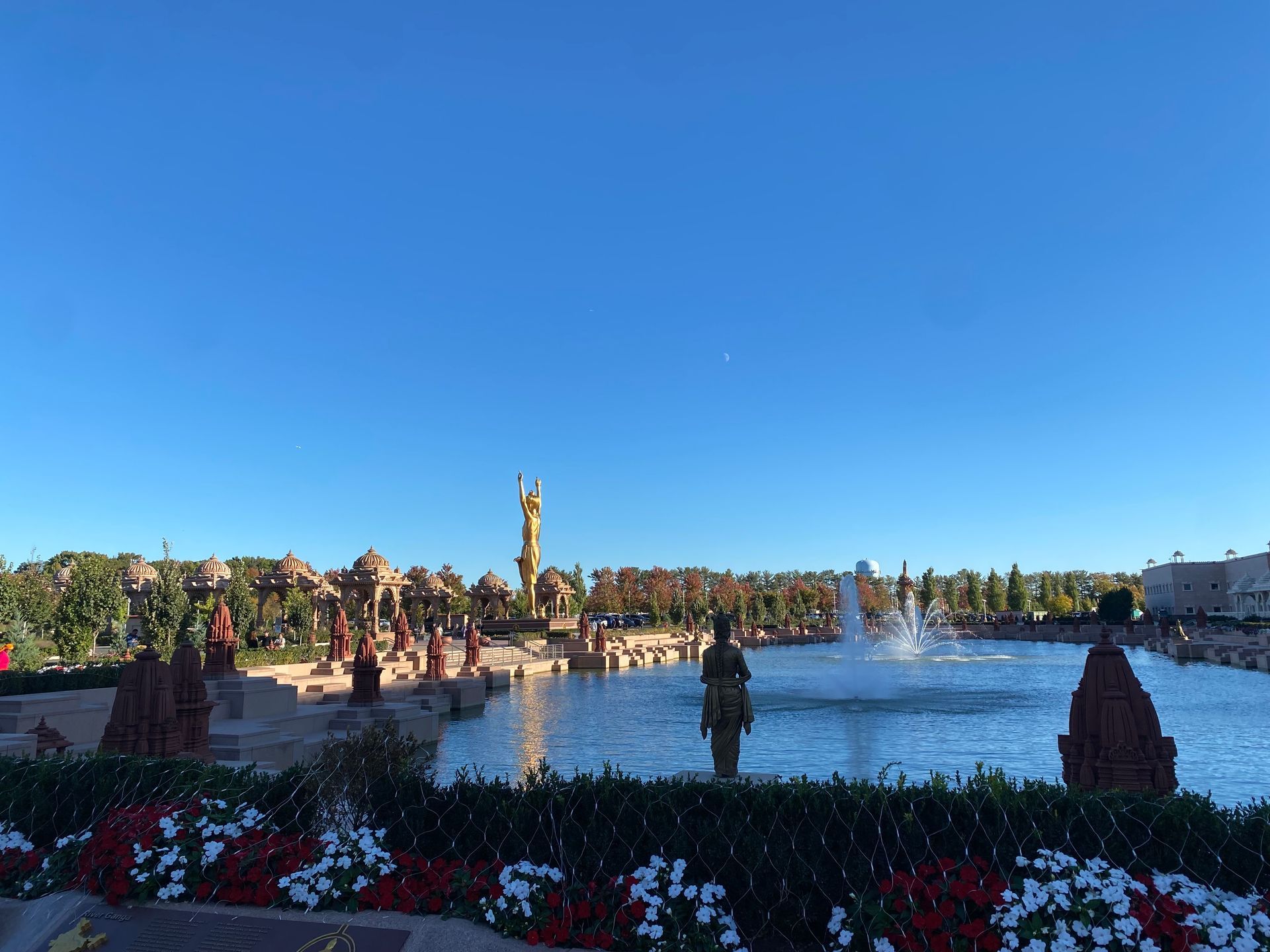 A fountain in a park with a blue sky in the background