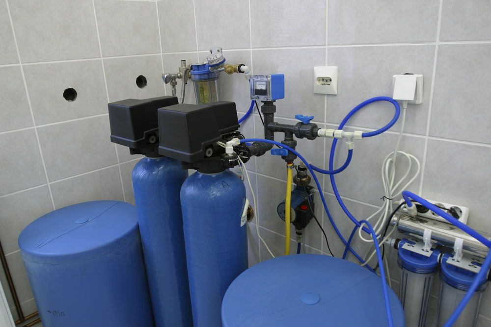 A Bathroom With Two Blue Tanks And A Water Filter — Peel Valley Plumbing In Hillvue, NSW