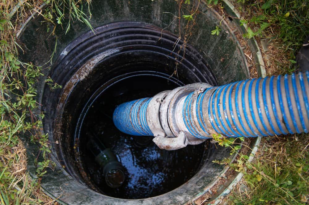 A Blue Hose Is Coming Out Of A Septic Tank — Peel Valley Plumbing In Hillvue, NSW