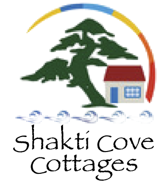 Shakti Cove Cottages logo with green tree, small cottage, and rainbow arc