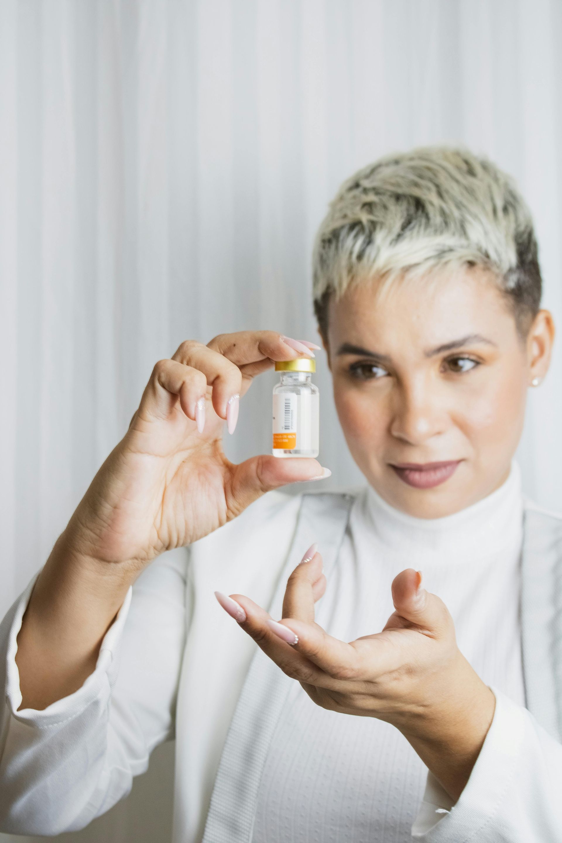A woman is holding a bottle of pills in her hand.