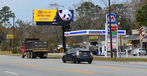 a reese 's billboard is on the side of the road