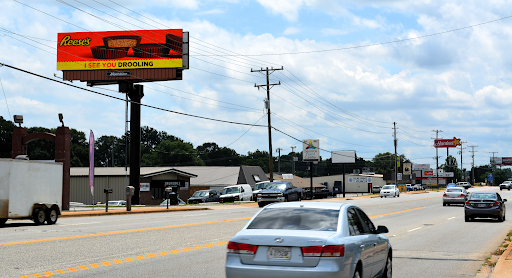 a reese 's billboard is on the side of the road