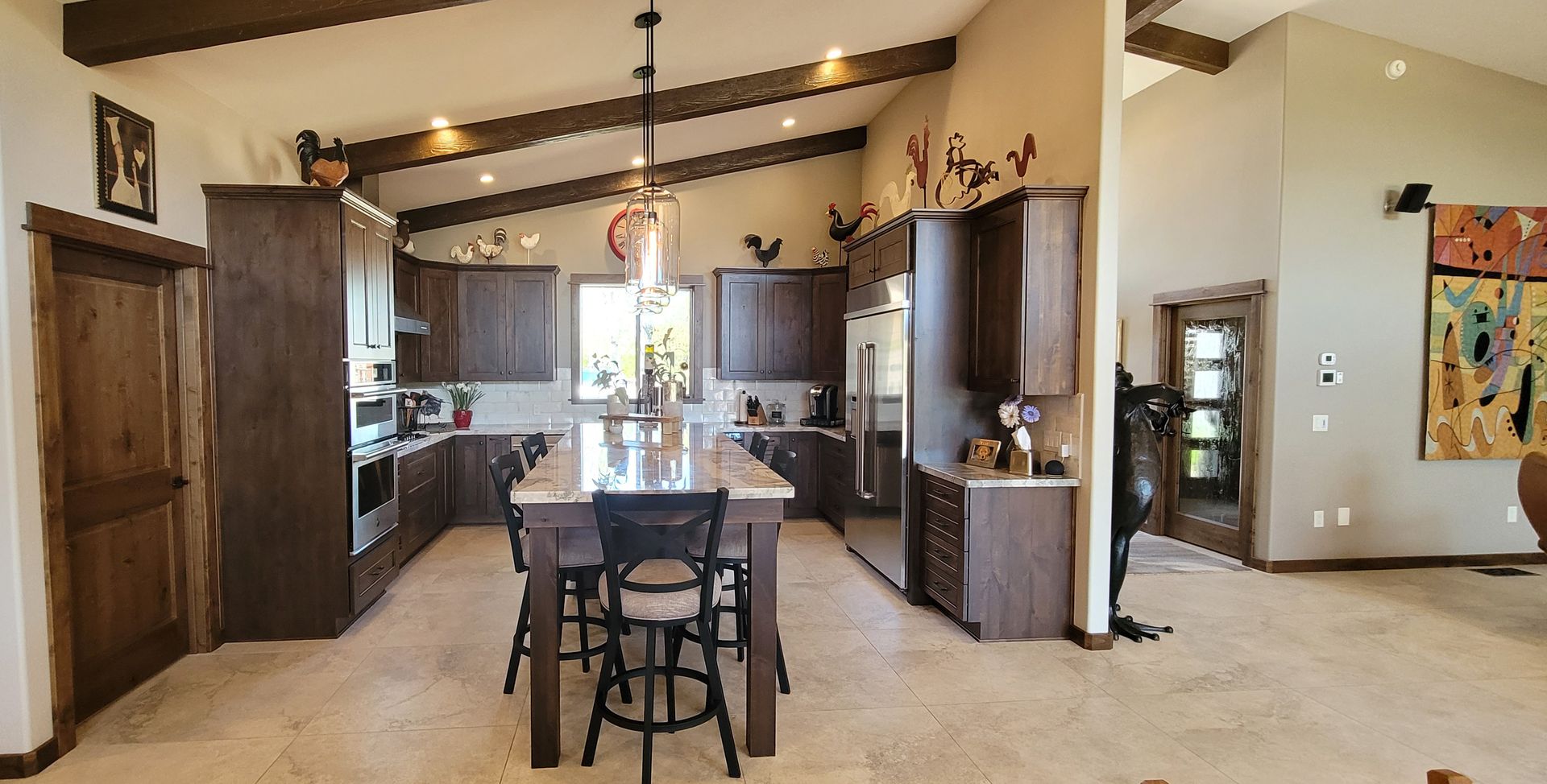 A kitchen with a large island and a refrigerator.