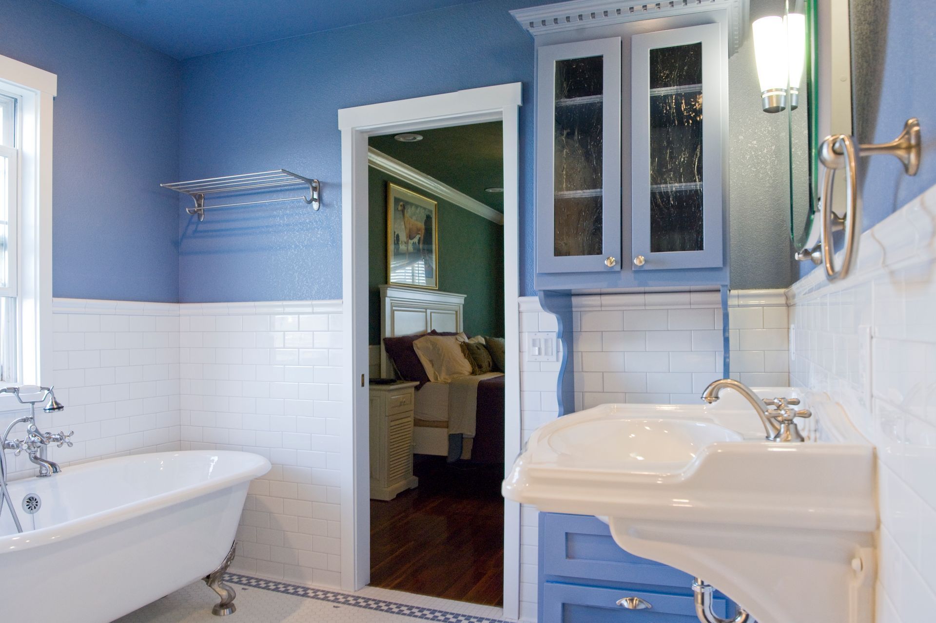 A bathroom with a tub , toilet , shower and window.