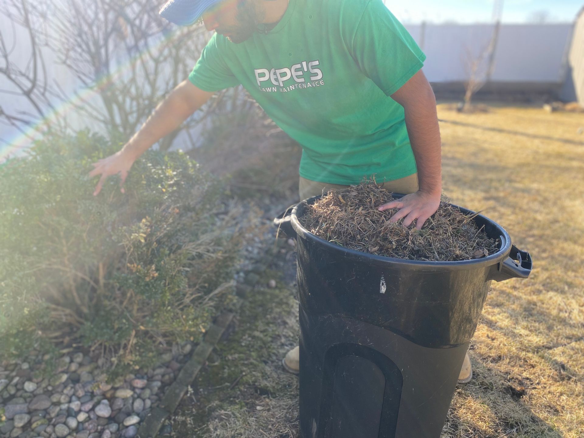 A rake is sitting on top of a pile of leaves.