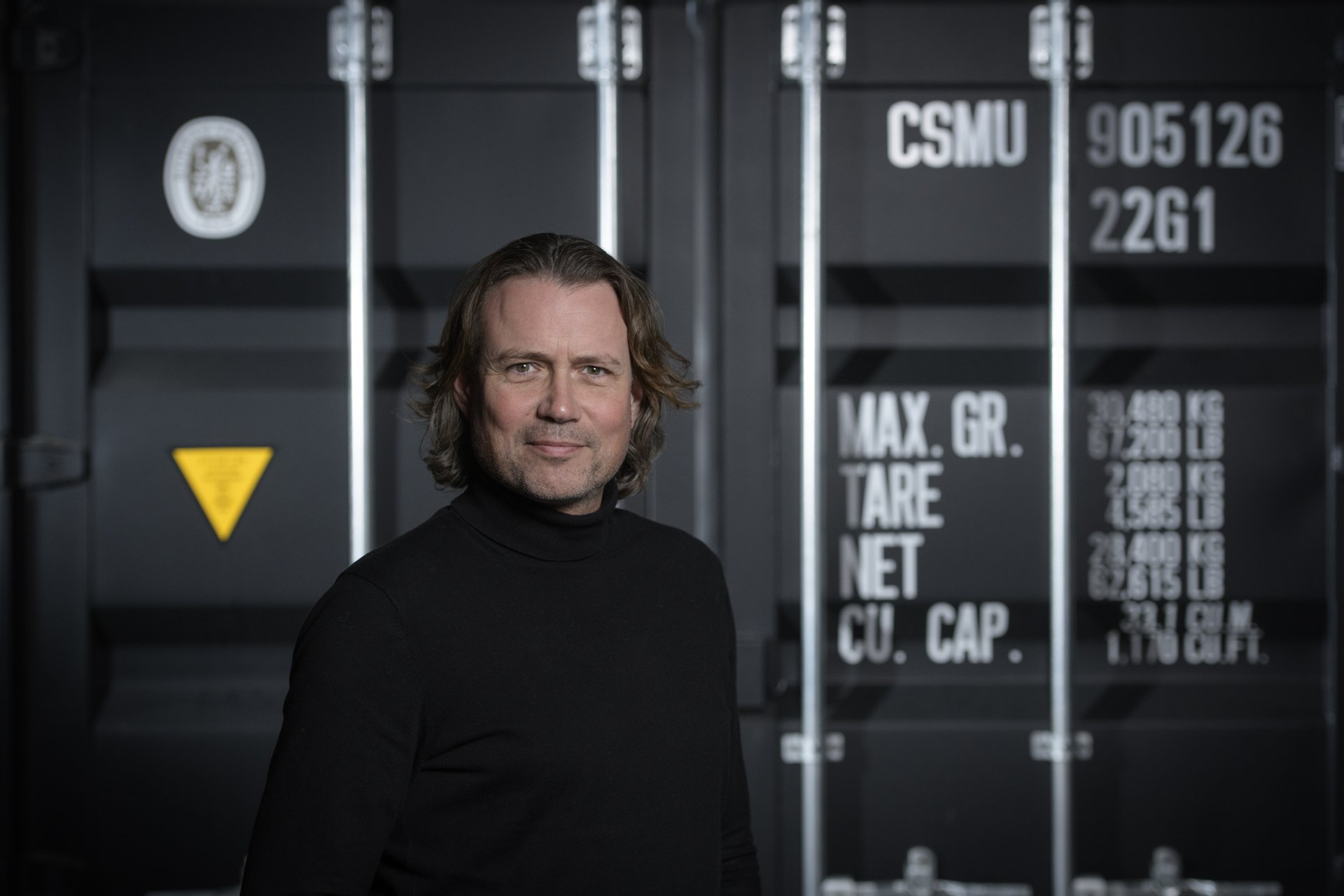 Diederik staat voor een zeecontainer.
