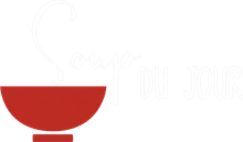 Red bowl with a white spoon and faint white text on a light background