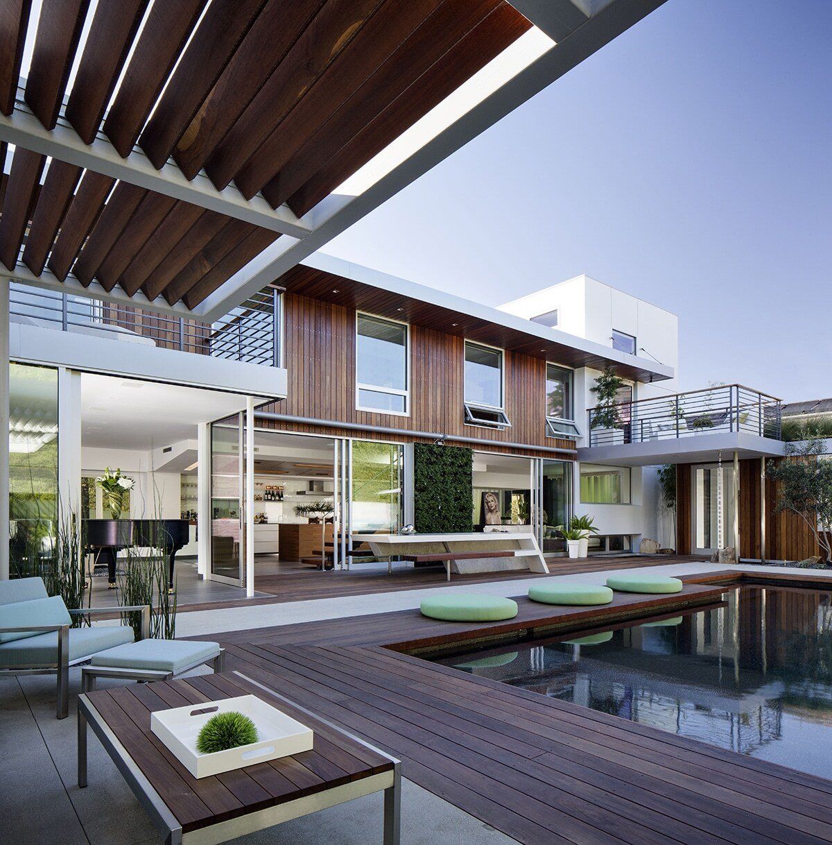 A large house with a swimming pool in front of it