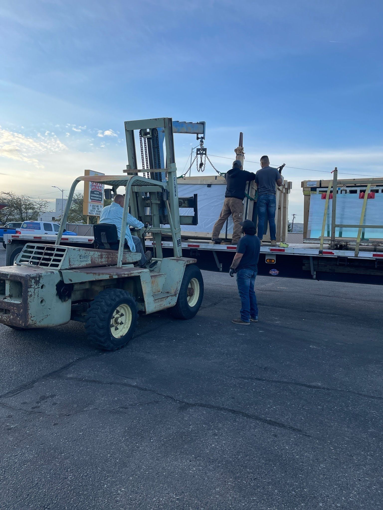 A forklift is being used to lift a container on a trailer.