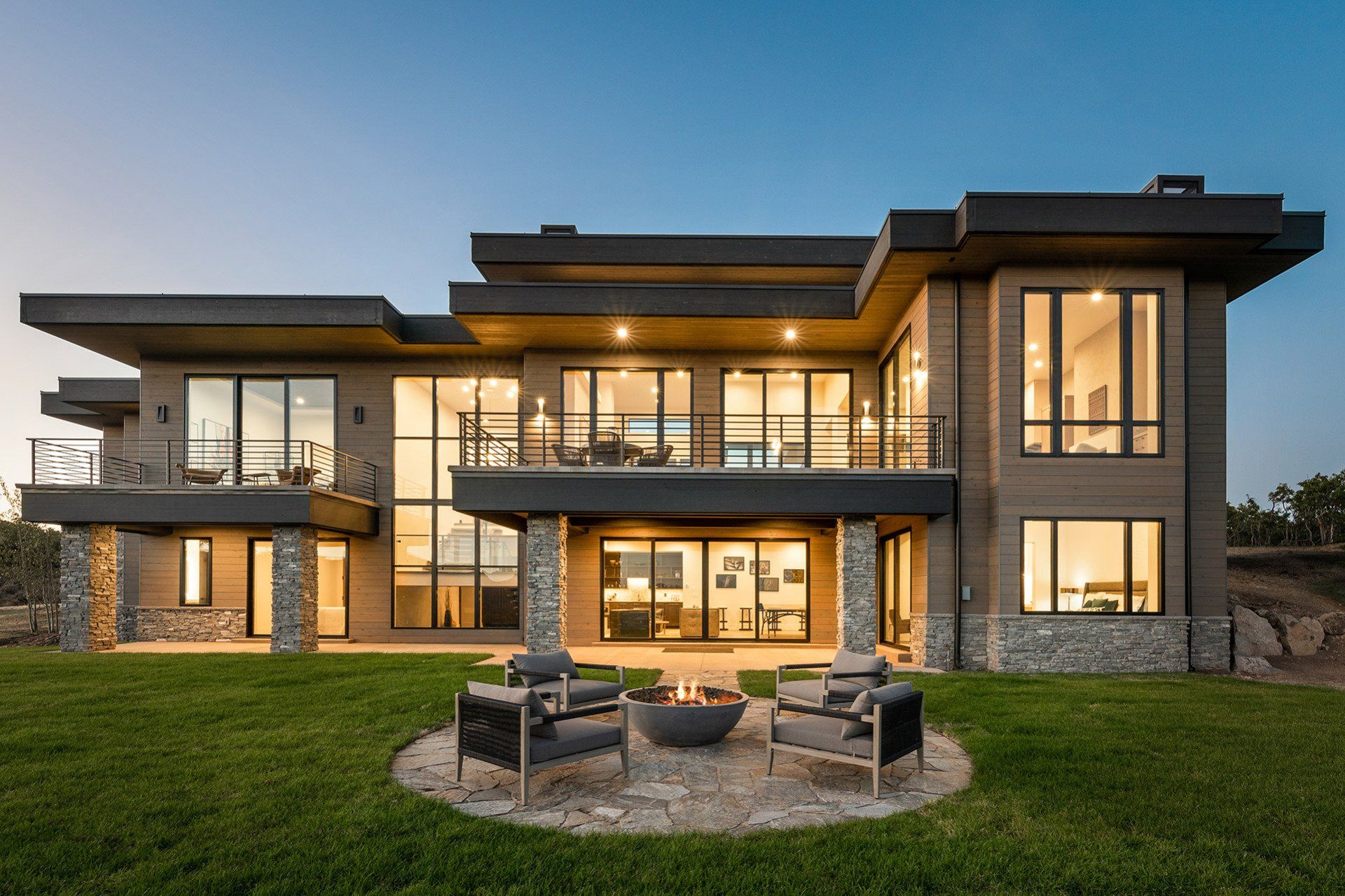 A large house with a fire pit in front of it.