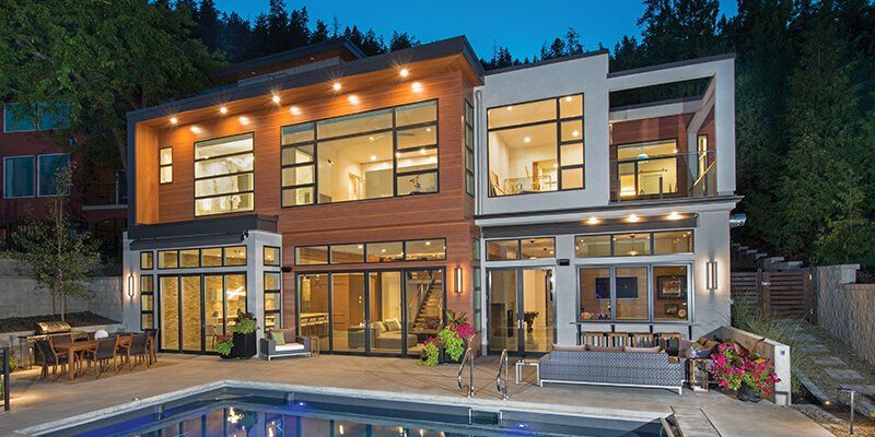 A large house with a swimming pool in front of it.