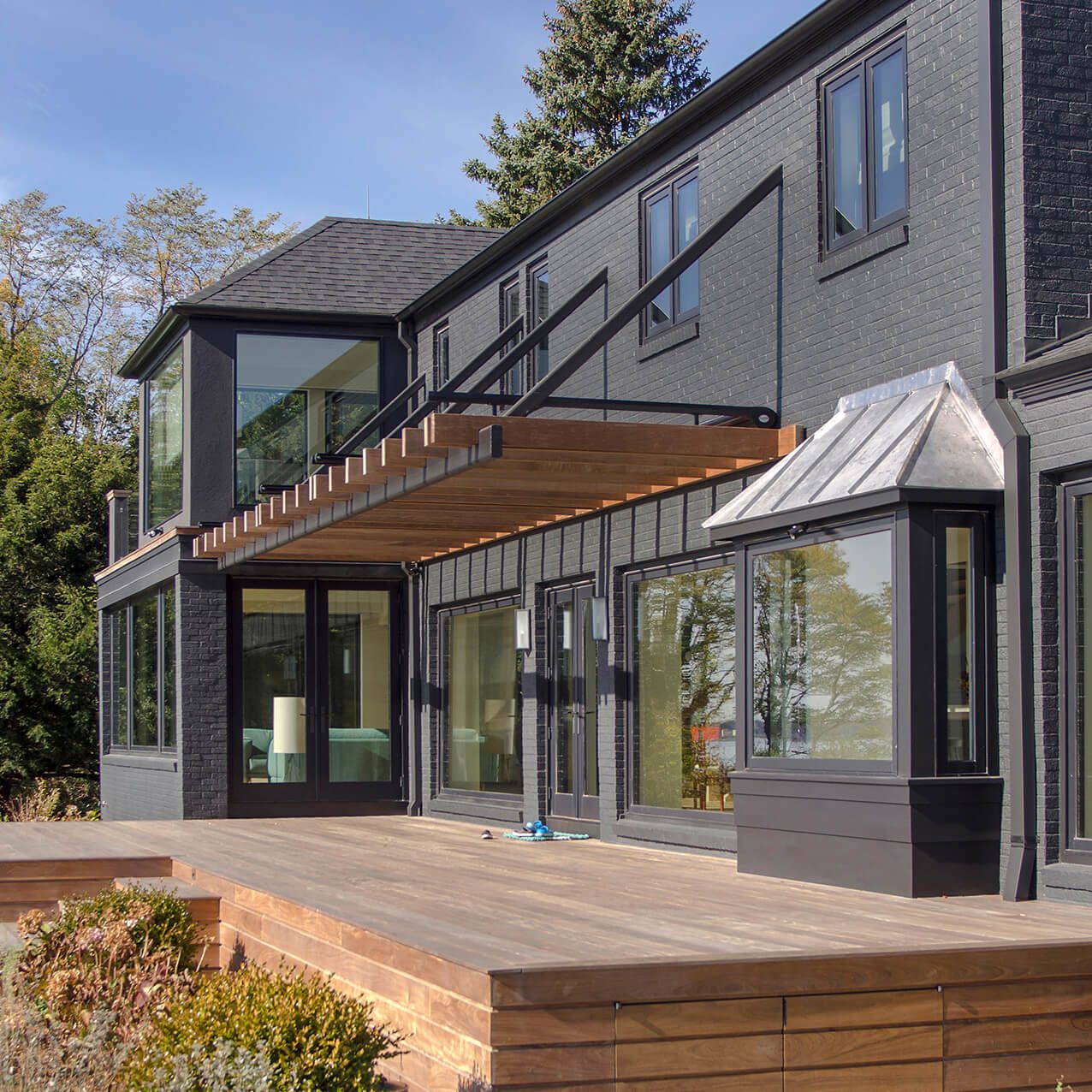 A large house with lots of windows and a wooden deck