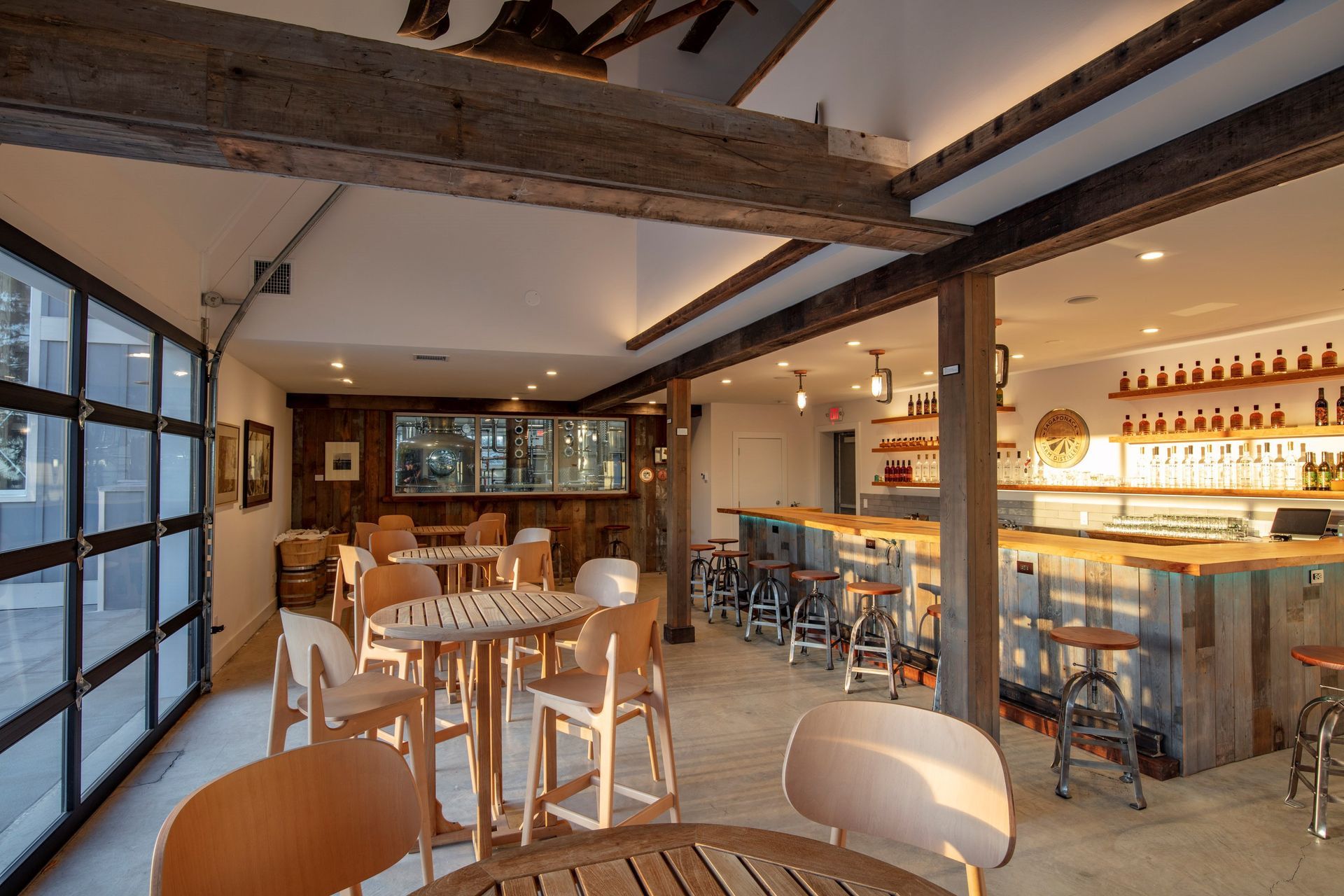 Sagaponak Faarm distillery Bar and Table seating - couches overlooking the Distillery room