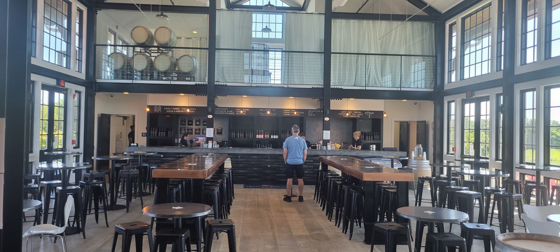 Kontokosta Winery Main Tasting Bar with double height ceilings for roomy effect and communal tables