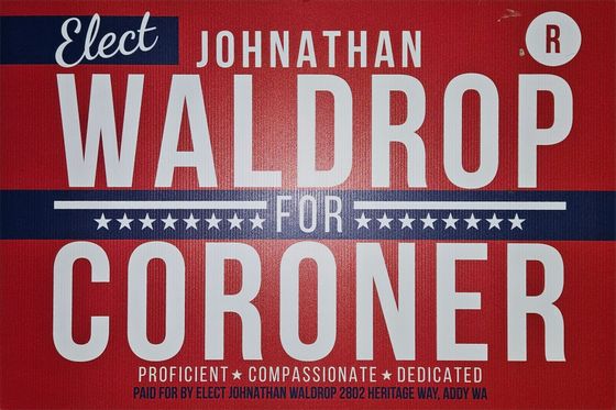 Campaign sign for Johnathan Waldrop for coroner, red, white, and blue with “Elect” and “Pro-client, compassionate, dedicated.”