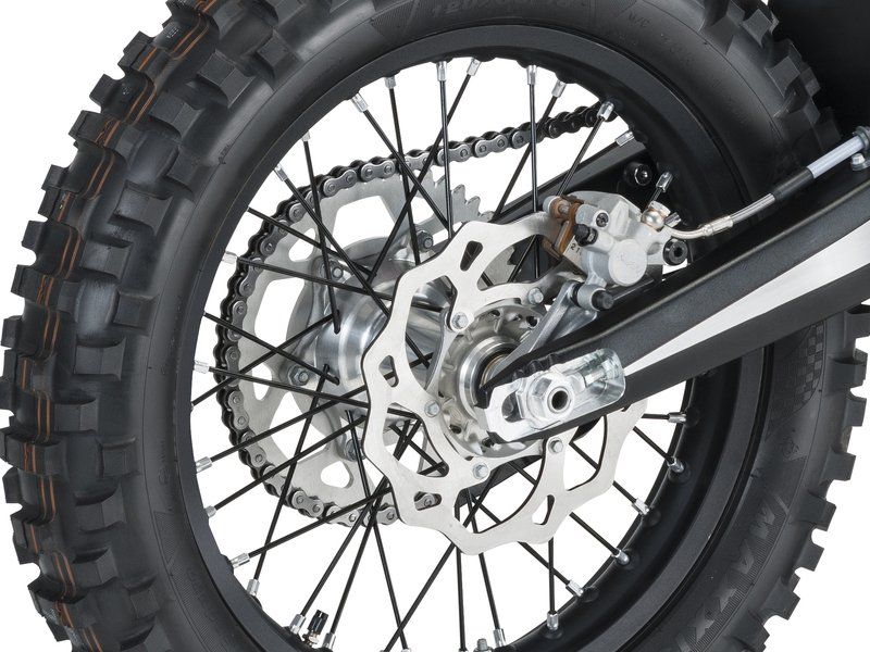 A close up of the rear wheel of a dirt bike
