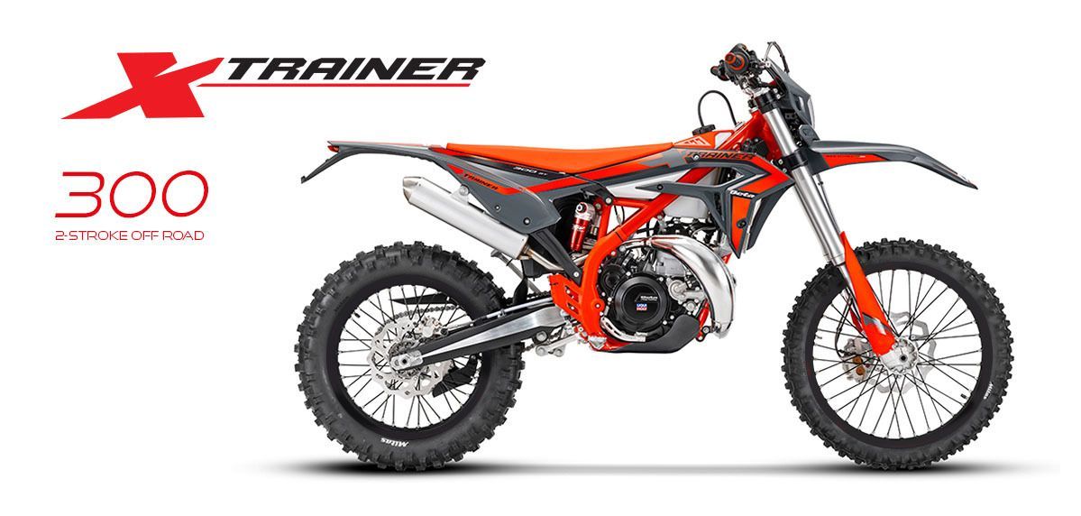 A red and black dirt bike is sitting on a white background.