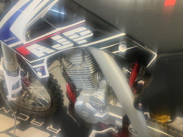 A close up of a motorcycle with the word racing on it