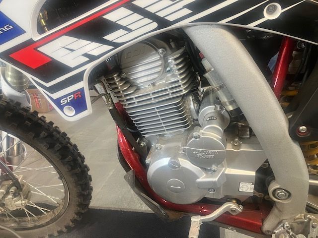 A close up of a motorcycle engine with a sticker on the side that says spf