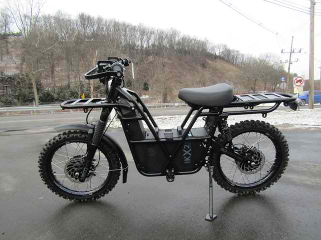 A black motorcycle is parked on the side of the road.