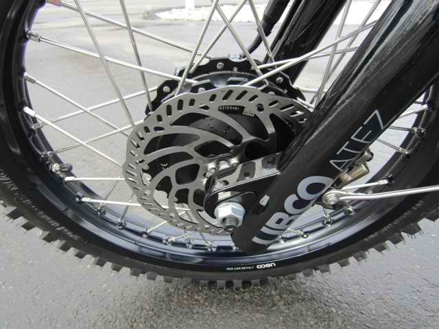 A close up of the front wheel of a dirt bike