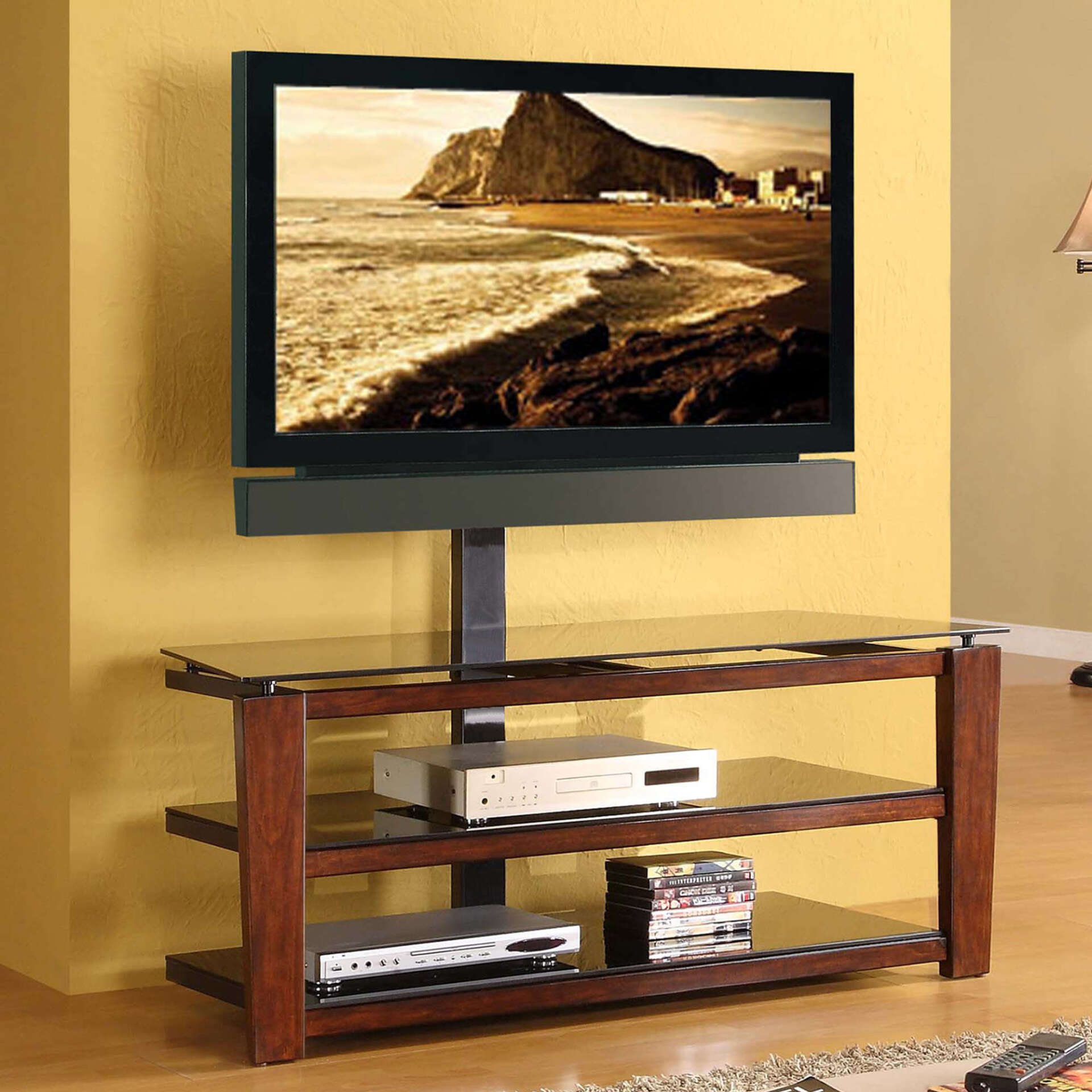 TV mounted on a stand with shelves. Features a scenic beach view on screen, brown wood, and glass shelves.