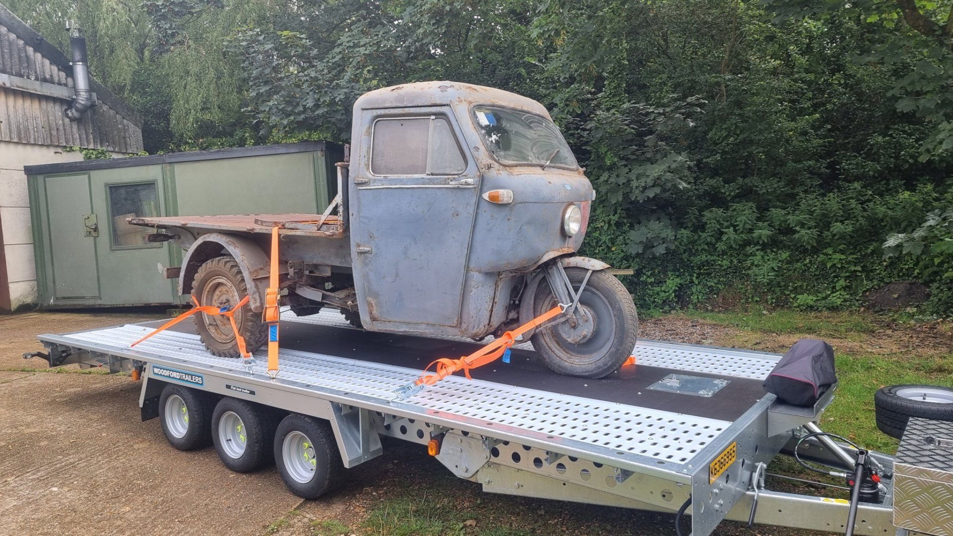A classic three wheeler on a trailer towed by a Mercedes Sprinter, ready for transport by MTC Transport