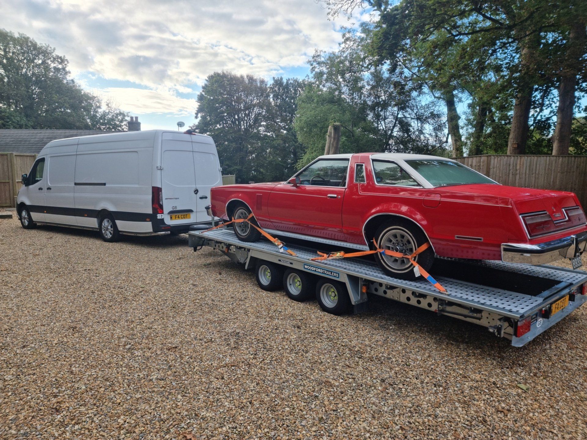 A classic car loaded on a trailer for transport by MTC Transport