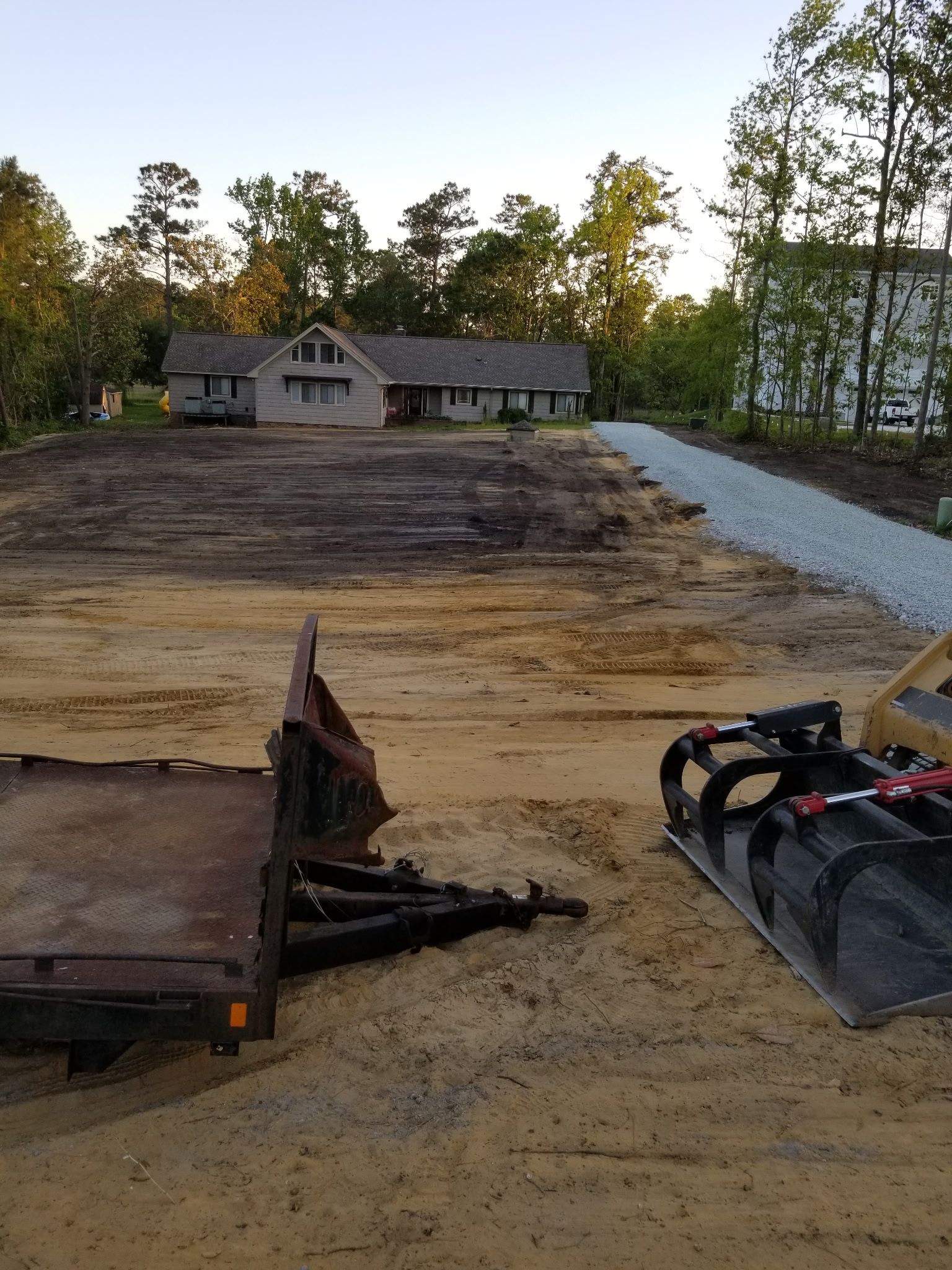Excavator loading dirt into a dump truck at a muddy construction site, with another machine nearby. Excavator loading dirt into a dump truck at a muddy construction site, with another machine nearby.
