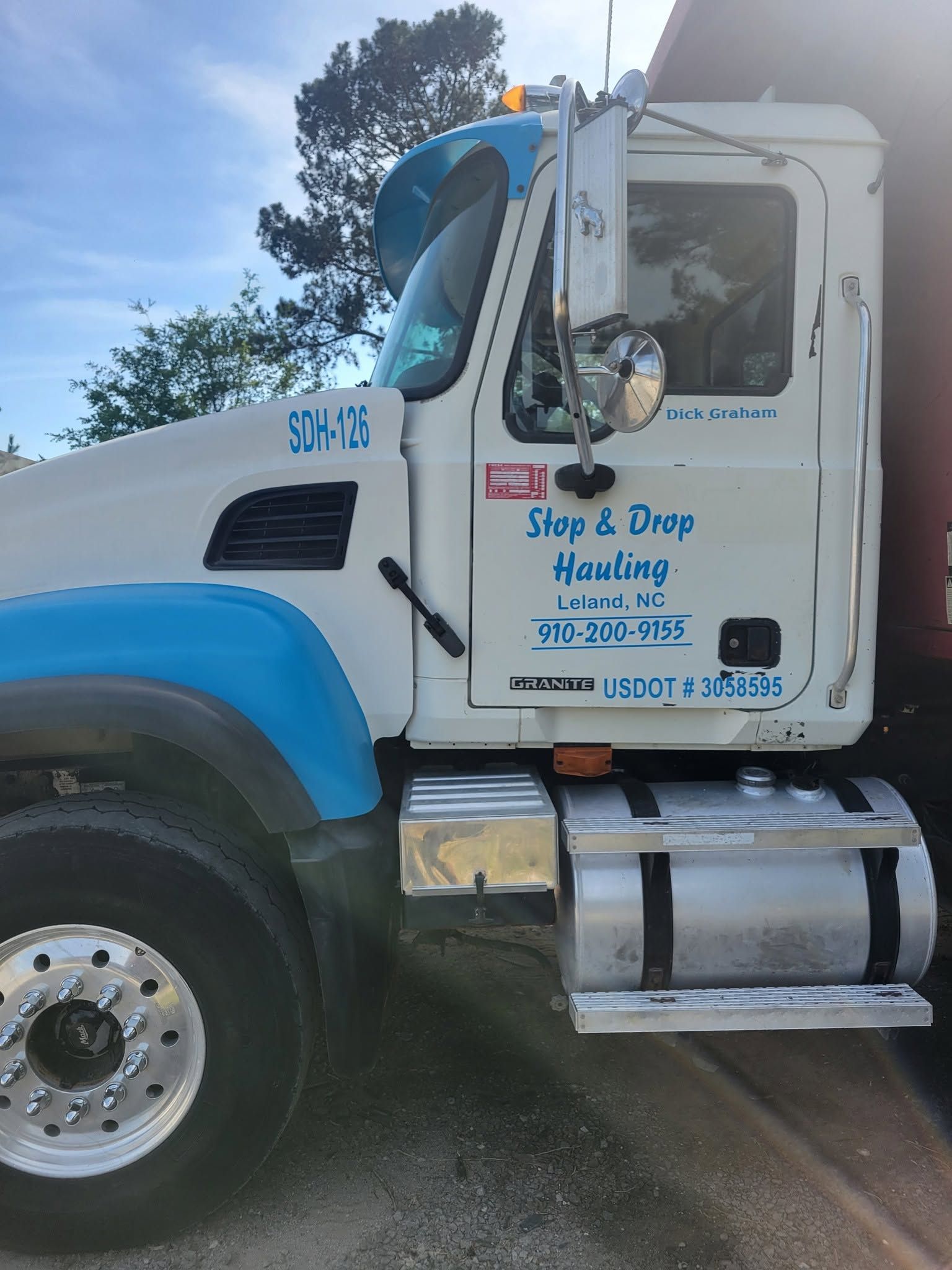 White and blue Slap & Tap Hauling truck parked outdoors on a sunny day White and blue Slap & Tap Hauling truck parked outdoors on a sunny day