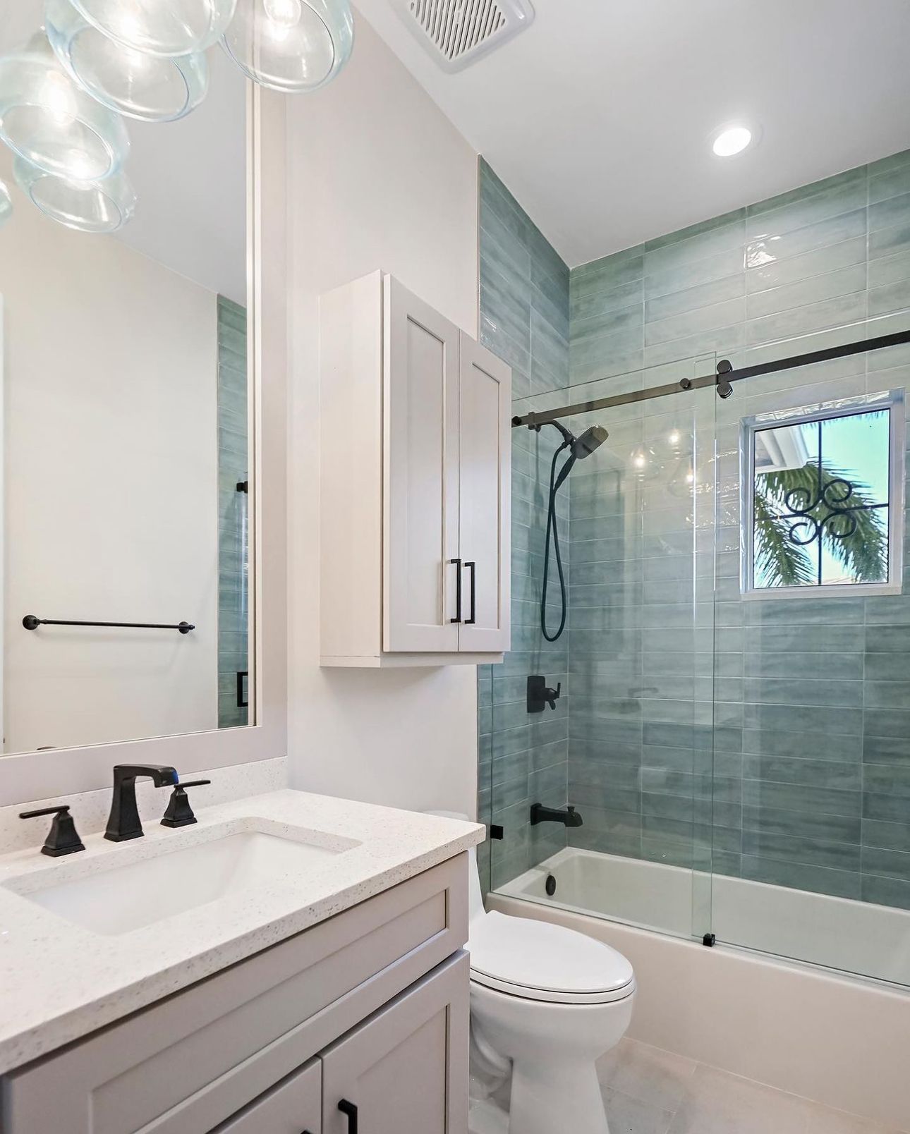 A bathroom with a sink, toilet, shower and bathtub.