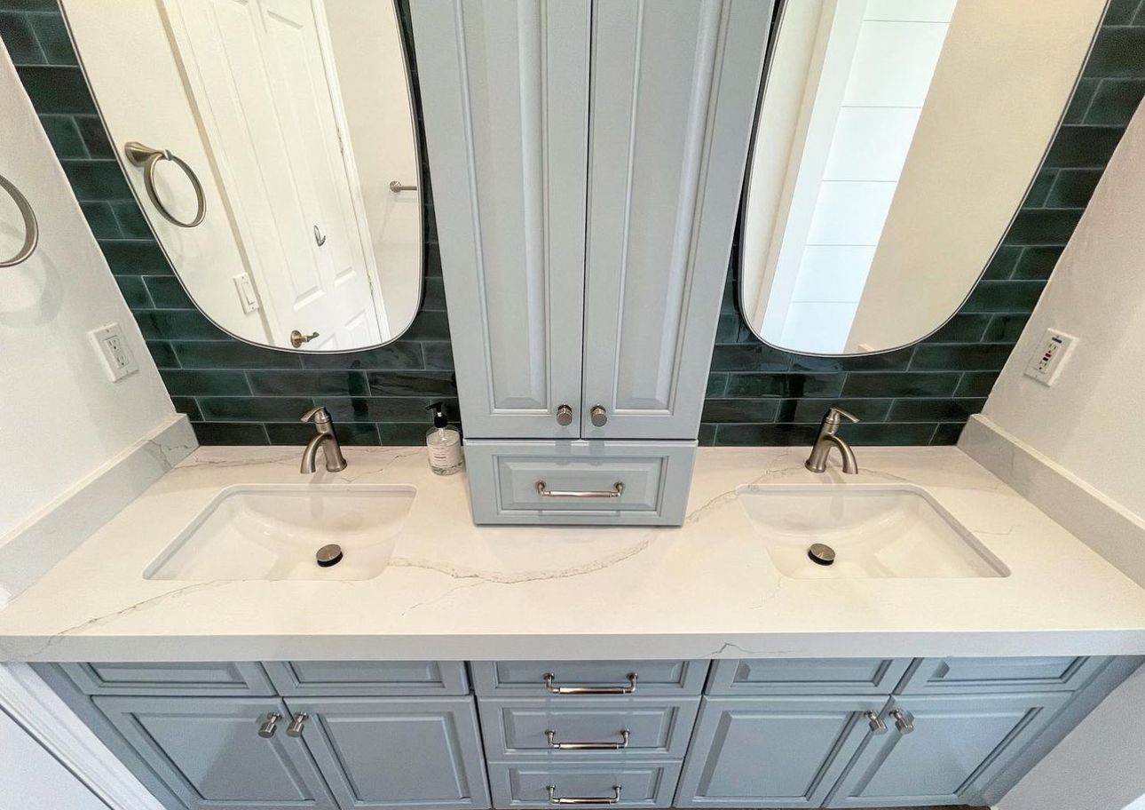 A bathroom with two sinks and two mirrors.
