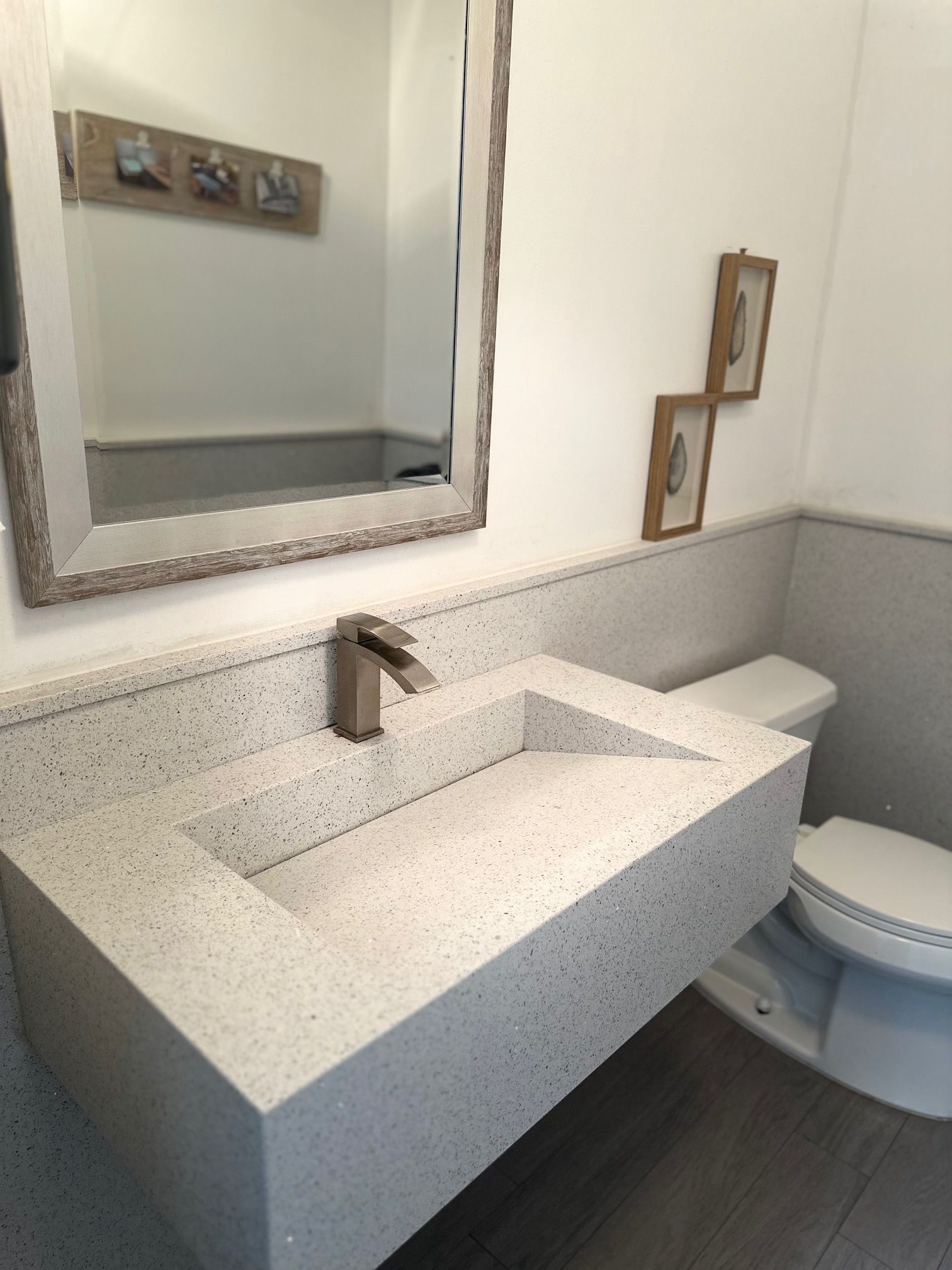 A bathroom with a toilet a sink and a mirror.