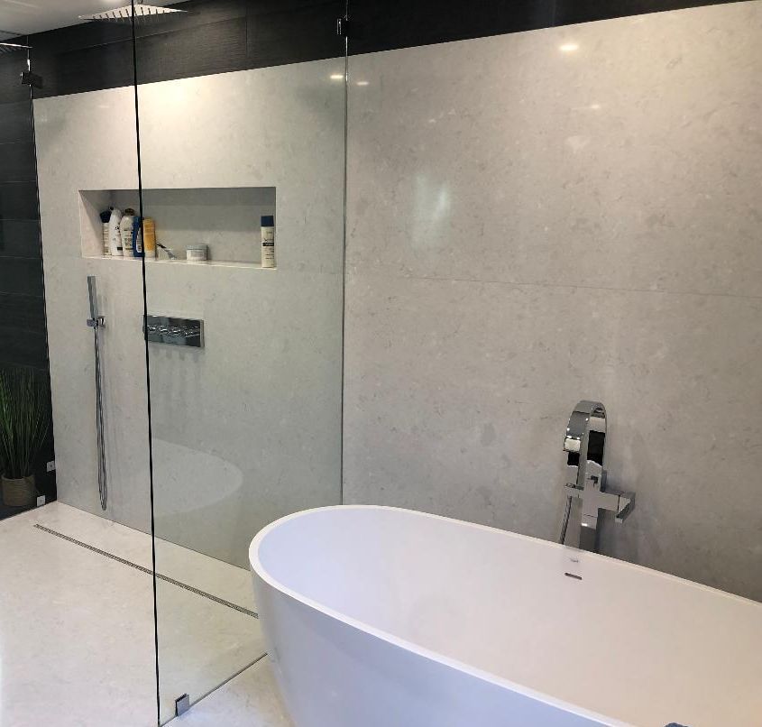 A bathroom with a bathtub and a walk in shower.
